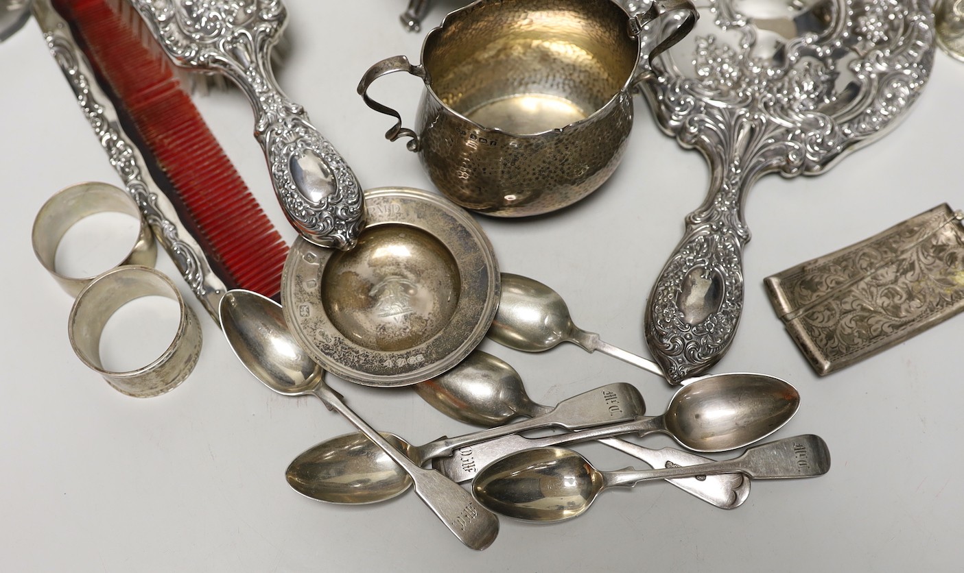 A late 19th/early 20th century French white metal coffee or chocolate pot (lacking handle), gross 21.5oz, a silver cream jug and sugar bowl, five French white metal mounted toilet jars, three silver napkin rings, a silve